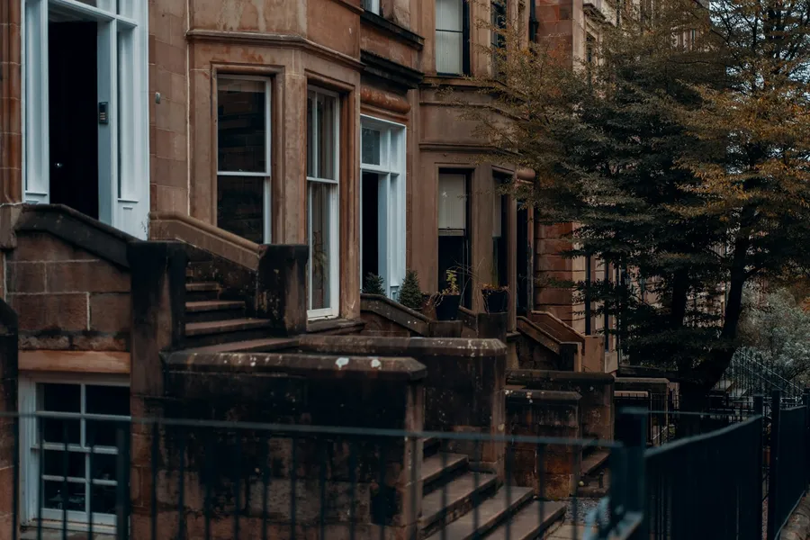 A row of traditional sandstone tenement flats in Glasgow's West End